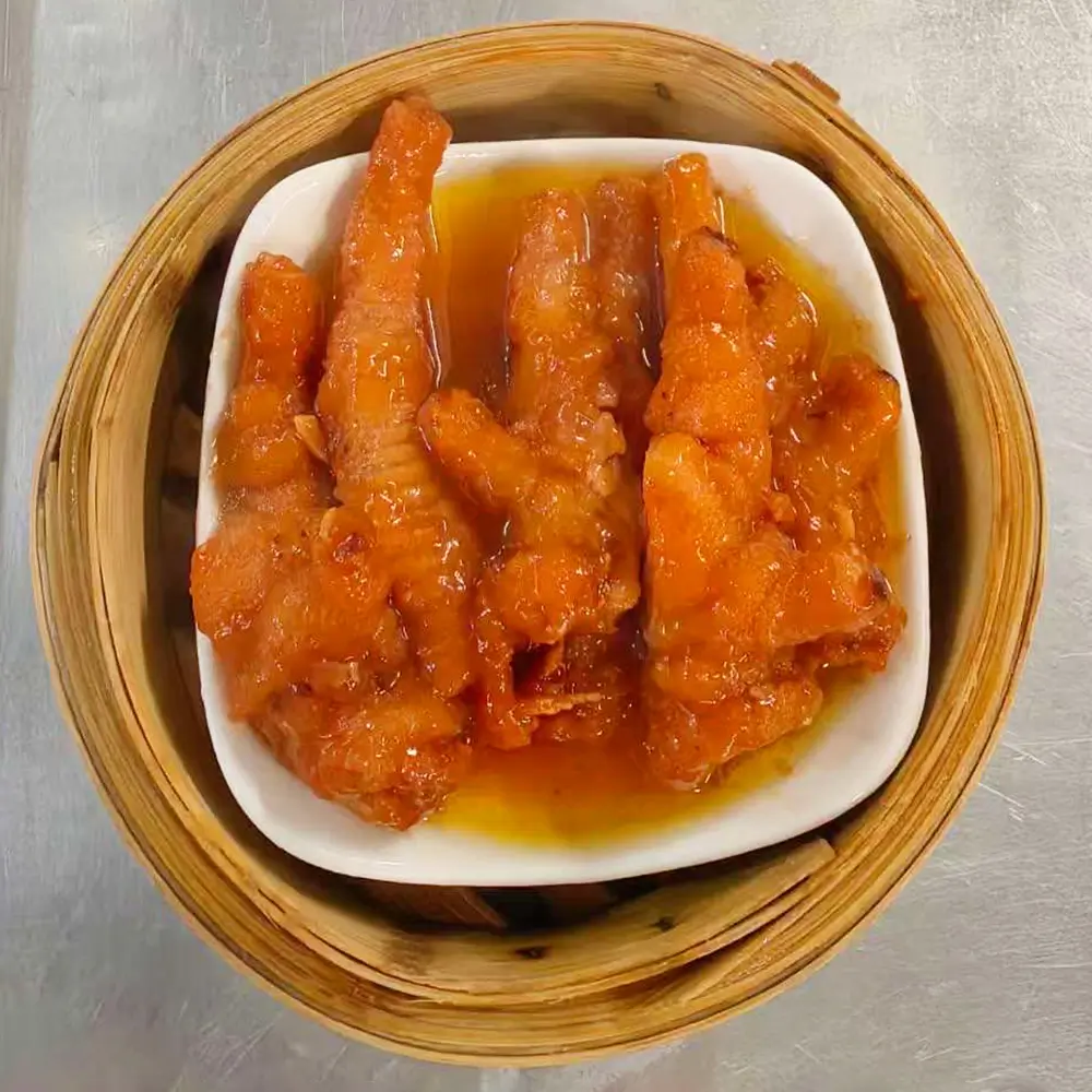 Chicken feet in sauce, served in bamboo steamer at Easy Joy Hot Pot Dim Sum Buffet，a Chinese Restaurant in New York