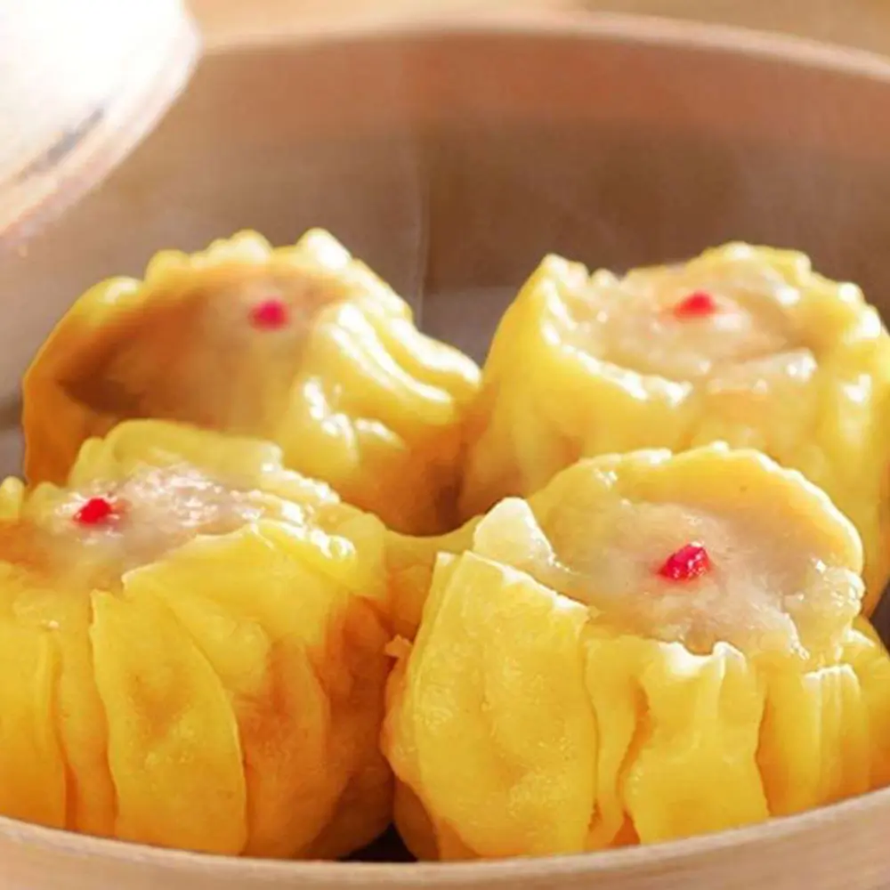 Four yellow shaomai with red dots at Easy Joy Hot Pot Dim Sum Buffet，a Chinese Restaurant in New York
